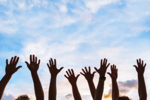 War Survivors Institute Creating a Movement hands raised to sky